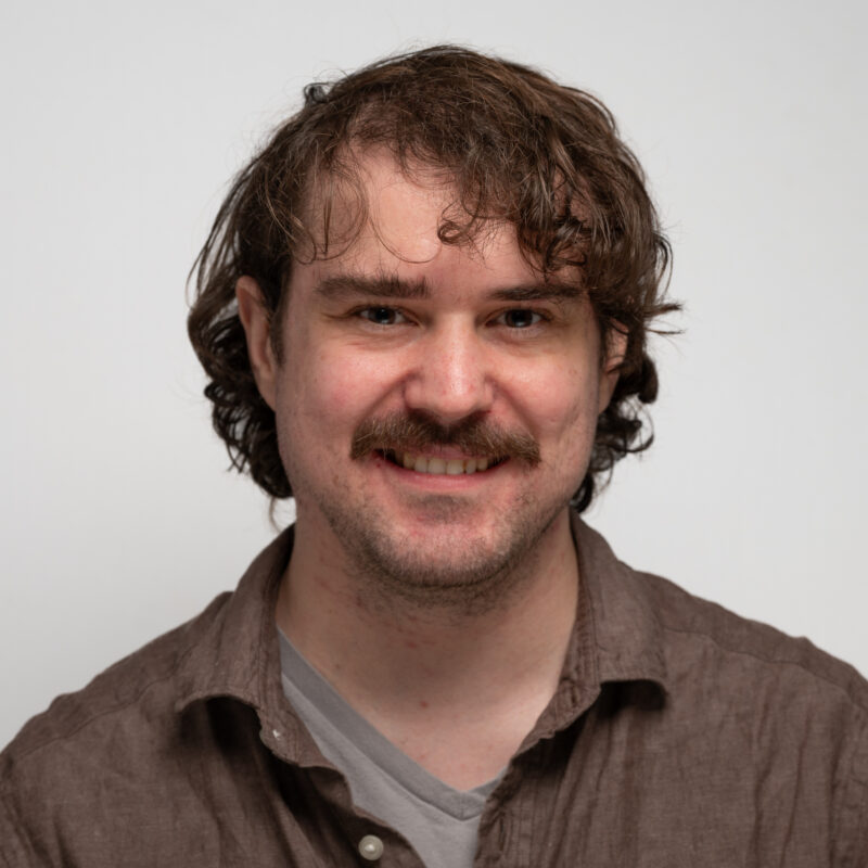 Man with brown hair and a moustache