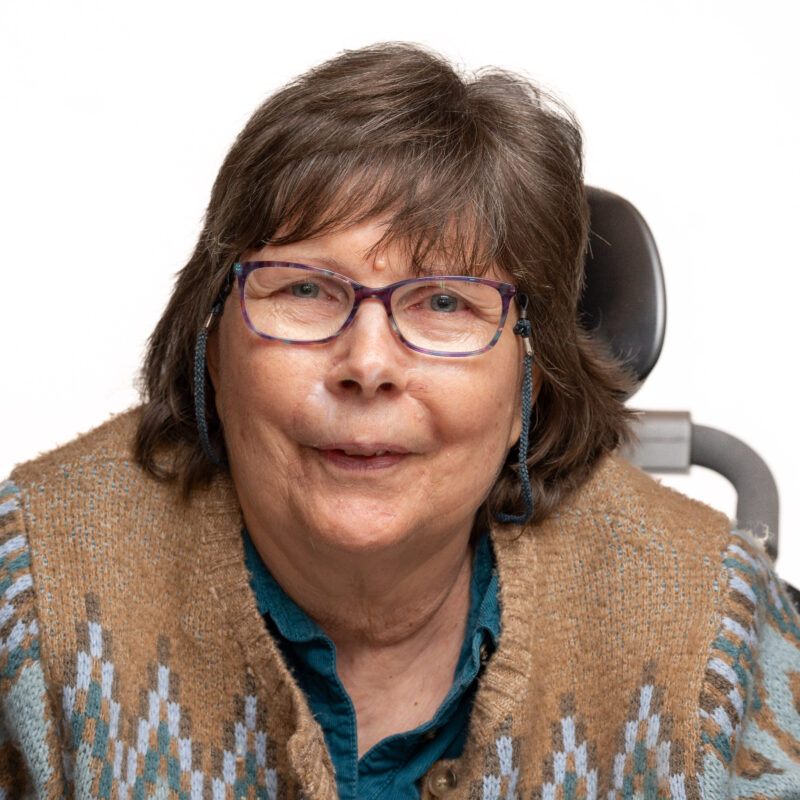Woman with short hair and glasses