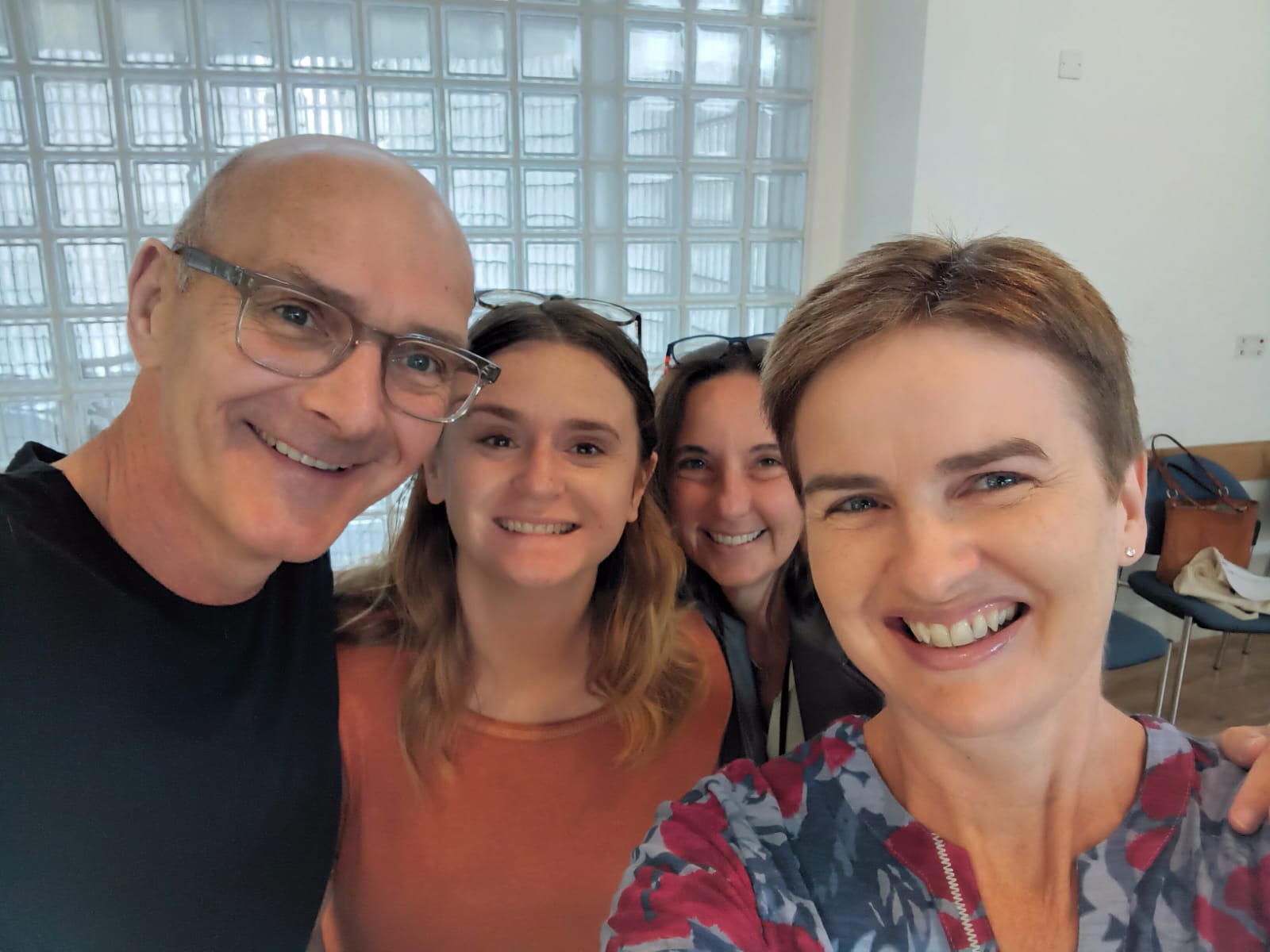 A selfie of Sue Martha Rachel and Alex, members of the children's team. They are smiling at the camera