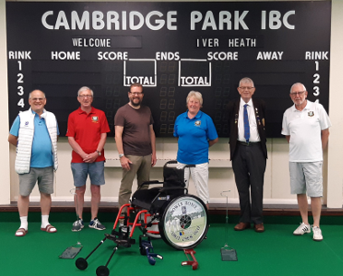 Image of 6 men standing in front of a score board at the Cambridge Park Bowls Club.