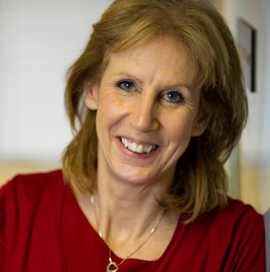 Woman with shoulder length hair and blue eyes
