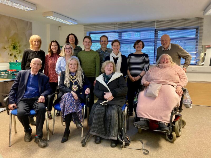 Group photos of Trustees sitting in a meeting room posing for a photo