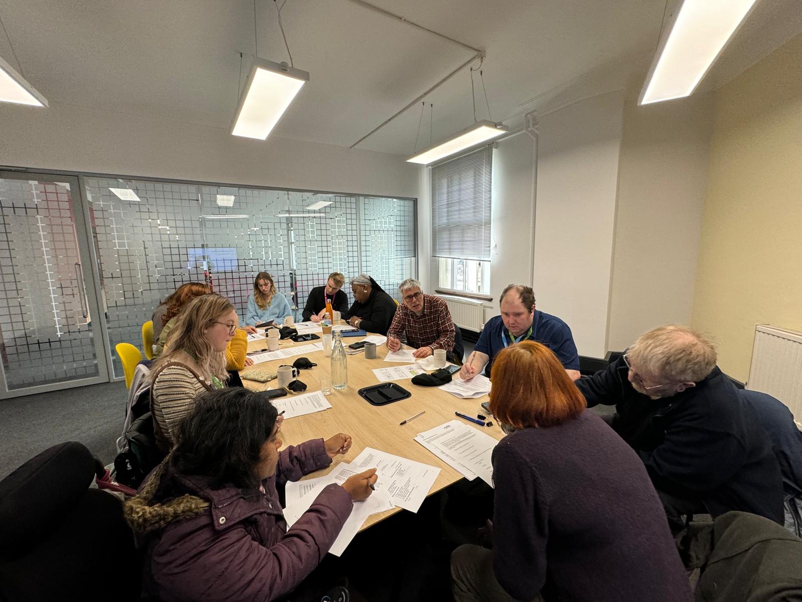 image of a group of people in a conference room having a group discussion