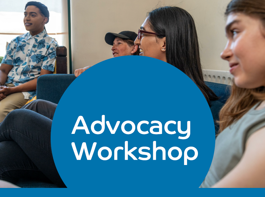 Image of a group of people in a relaxed meeting setting. There is a big circle in the middle of the photo that reads 'Advocacy Workshop'. The circle is blue with white text.